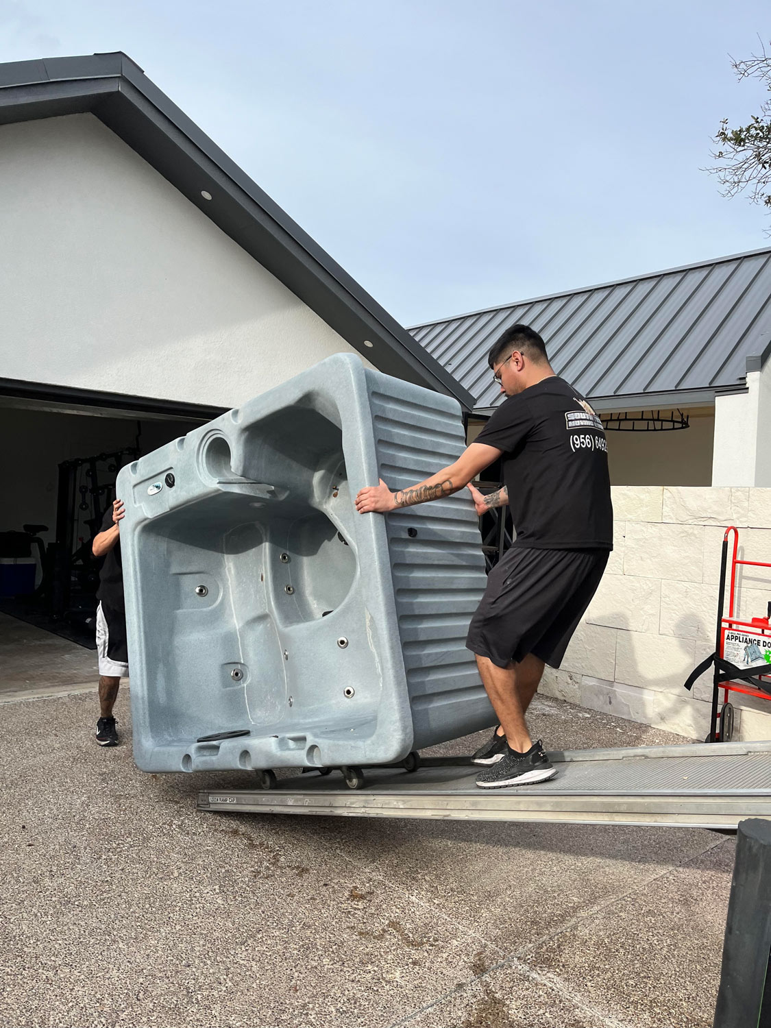 image of movers moving large hot tub